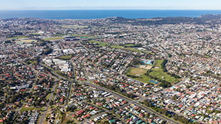 View from the air looking over Newcastle area including properties and coast.