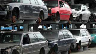 Wrecked and dismantled cars on a junkyard.