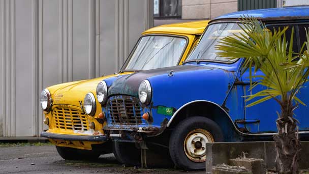 Two old vehicles parked in the garage