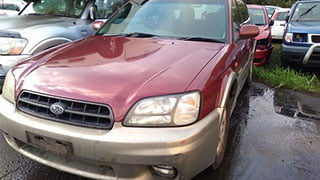 Maroon coloured Subaru vehicle on our wrecking yard.