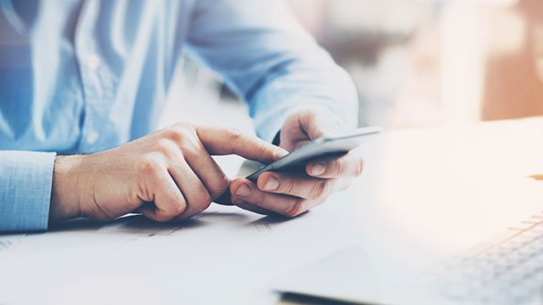 Man searching for business details on smartphone