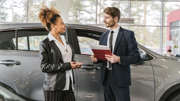 Professional car dealers in a car dealership store.
